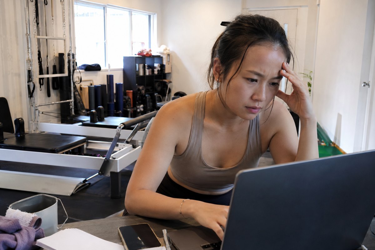 A small business owner using an AI chat assistant on a laptop